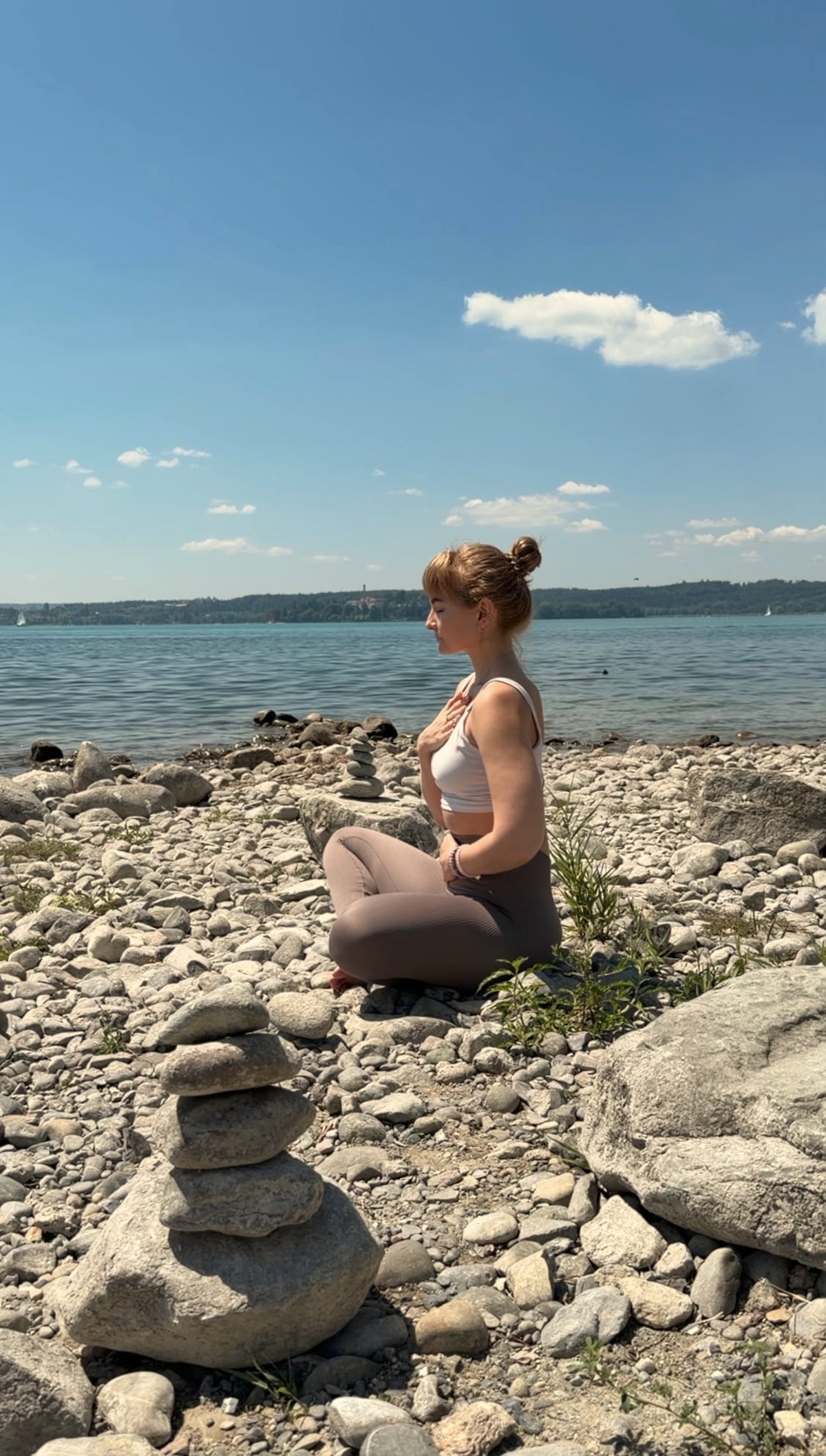 Frau sitzt ruhig am Wasser